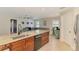 Well-designed kitchen with stainless steel appliances, granite countertops, and open layout to the living area at 227 Monet Dr, Nokomis, FL 34275