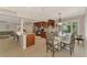 Open kitchen flows to dining with stainless appliances, bar seating and ample counter space at 227 Monet Dr, Nokomis, FL 34275