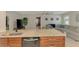 Kitchen island featuring a stainless steel sink, granite countertop, and an open view of the living room at 227 Monet Dr, Nokomis, FL 34275