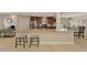 Spacious kitchen island with granite countertop and seating, complemented by stainless steel appliances and wooden cabinets at 227 Monet Dr, Nokomis, FL 34275