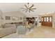 Open-concept living room featuring a large sectional sofa, neutral decor, and an inviting entryway at 227 Monet Dr, Nokomis, FL 34275