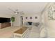 Bright, open-concept living room with large windows, and a gray sectional for ample seating at 227 Monet Dr, Nokomis, FL 34275