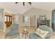 Cozy living area featuring vaulted ceiling, fireplace, and stylish furniture in a brightly lit space at 227 Monet Dr, Nokomis, FL 34275