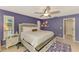 Comfortable main bedroom with a large window for natural light, ceiling fan, and an en suite bathroom at 227 Monet Dr, Nokomis, FL 34275