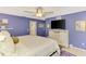 Comfortable main bedroom with a ceiling fan, wall art, and sliding doors for easy access to the en suite at 227 Monet Dr, Nokomis, FL 34275