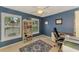 Home office featuring large windows, a bookshelf, and a desk with a rolling chair at 227 Monet Dr, Nokomis, FL 34275