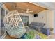 Covered patio featuring a hanging chair, a sofa, and a decorative ceiling at 227 Monet Dr, Nokomis, FL 34275