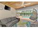 Enclosed patio featuring a hanging chair, a sofa, and a view of the pool at 227 Monet Dr, Nokomis, FL 34275