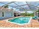 Sparkling screened pool featuring cool, blue water and a brick paver deck at 227 Monet Dr, Nokomis, FL 34275