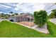 Home's screened pool and patio area, complemented by lush green lawn and landscaping at 227 Monet Dr, Nokomis, FL 34275