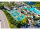 Aerial view showcasing community tennis courts and a resort-style swimming pool at 2411 New Haven Cir # 70, Sun City Center, FL 33573