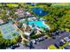 Aerial view showcasing a community pool, tennis courts, and well-maintained landscaping at 2411 New Haven Cir # 70, Sun City Center, FL 33573