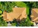 Aerial view of the property showcasing the roof, landscaping, and surrounding greenery at 2411 New Haven Cir # 70, Sun City Center, FL 33573