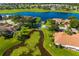 An aerial view showcasing lakefront houses in a beautiful neighborhood at 2411 New Haven Cir # 70, Sun City Center, FL 33573