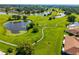 Scenic aerial view of lush green spaces, walking paths, and tranquil ponds in a beautiful community at 2411 New Haven Cir # 70, Sun City Center, FL 33573