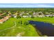 An aerial view of the community showcasing the neighborhood and lush pond at 2411 New Haven Cir # 70, Sun City Center, FL 33573