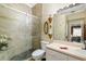 Elegantly appointed bathroom featuring stylish glass shower with stone flooring and neutral-colored tiling at 2411 New Haven Cir # 70, Sun City Center, FL 33573