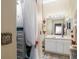 Bathroom featuring a vanity and mirror that leads to a walk-in closet with organizer at 2411 New Haven Cir # 70, Sun City Center, FL 33573