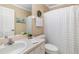 Well-lit bathroom featuring a sink vanity and shower tub with matching neutral-colored decor at 2411 New Haven Cir # 70, Sun City Center, FL 33573