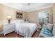 Cozy bedroom showcasing bright window views and white wicker decor with light-filled ambiance at 2411 New Haven Cir # 70, Sun City Center, FL 33573