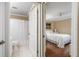 Bright bedroom featuring hardwood floors and an ensuite bathroom with tiled floors at 2411 New Haven Cir # 70, Sun City Center, FL 33573