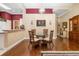 Elegant dining area with hardwood floors, a stylish chandelier, and a glass table at 2411 New Haven Cir # 70, Sun City Center, FL 33573
