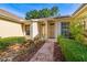 Charming home entrance with brick path, meticulous landscaping, and decorative water feature at 2411 New Haven Cir # 70, Sun City Center, FL 33573