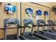 Fitness center with multiple treadmills and wall-mounted TVs at 2411 New Haven Cir # 70, Sun City Center, FL 33573