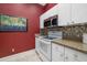 Modern kitchen showcasing white appliances, stylish backsplash, and red accents at 2411 New Haven Cir # 70, Sun City Center, FL 33573