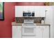Well-equipped kitchen features white cabinets, stainless steel appliances, and ample counter space at 2411 New Haven Cir # 70, Sun City Center, FL 33573