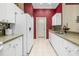 Bright kitchen with white cabinets, granite countertops, and stainless steel sink at 2411 New Haven Cir # 70, Sun City Center, FL 33573