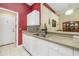 Stylish kitchen with white cabinetry, mosaic backsplash, and granite countertops at 2411 New Haven Cir # 70, Sun City Center, FL 33573