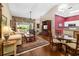 Spacious living room with hardwood floors, stone fireplace, and abundant natural light at 2411 New Haven Cir # 70, Sun City Center, FL 33573