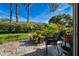 Inviting patio area with stone accents, surrounded by a well-manicured garden at 2411 New Haven Cir # 70, Sun City Center, FL 33573