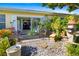 Charming patio with lush greenery and a view into the home's sunroom at 2411 New Haven Cir # 70, Sun City Center, FL 33573