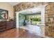 Bright sunroom with stone accent wall, leading to a delightful outdoor patio at 2411 New Haven Cir # 70, Sun City Center, FL 33573
