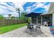 Stone patio in fenced back yard, with outdoor dining set and room for entertaining and relaxing at 2512 Jamaica St, Sarasota, FL 34231