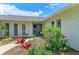 Inviting front entrance with double doors, decorative plants and flowers surrounding the walkway to home at 2512 Jamaica St, Sarasota, FL 34231
