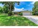 Well maintained single story home with a manicured lawn, mature shade trees, and a two car garage at 2512 Jamaica St, Sarasota, FL 34231