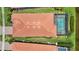 Aerial of tile roof and screened in pool, plus green grass and landscaping at 25143 Spartina Dr, Venice, FL 34293