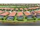Aerial view featuring waterfront homes with screened-in pools and well-maintained landscaping at 25143 Spartina Dr, Venice, FL 34293