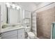 This bathroom offers a tiled shower, white cabinets, and a white countertop at 25143 Spartina Dr, Venice, FL 34293