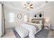 Tranquil bedroom featuring a tray ceiling, plush carpet, and neutral decor at 25143 Spartina Dr, Venice, FL 34293