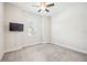 This bedroom offers neutral colored walls, carpet and a ceiling fan at 25143 Spartina Dr, Venice, FL 34293