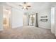 Bright bedroom with neutral walls and carpet, ceiling fan, and sliding glass doors to a patio at 25143 Spartina Dr, Venice, FL 34293