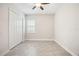 This secondary bedroom has a ceiling fan, a closet, and neutral walls at 25143 Spartina Dr, Venice, FL 34293