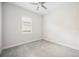 This bedroom offers neutral colored walls, carpet and a ceiling fan at 25143 Spartina Dr, Venice, FL 34293
