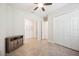 This bedroom features a ceiling fan, neutral walls, and a double closet at 25143 Spartina Dr, Venice, FL 34293