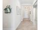 Inviting hallway with neutral paint, crown molding, and decorative wall art at 25143 Spartina Dr, Venice, FL 34293