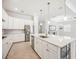 Modern kitchen with white cabinets, center island, stainless appliances, and stone countertops at 25143 Spartina Dr, Venice, FL 34293